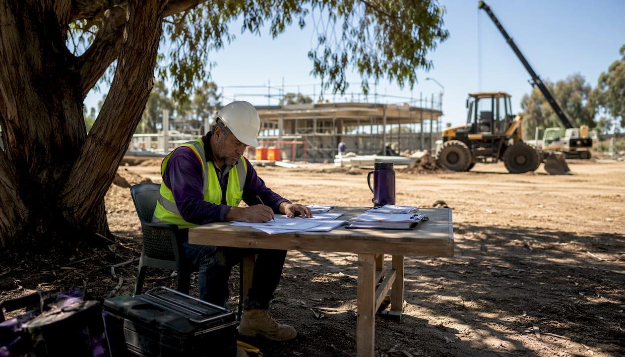 Tradie reviewing WHS plan on construction site