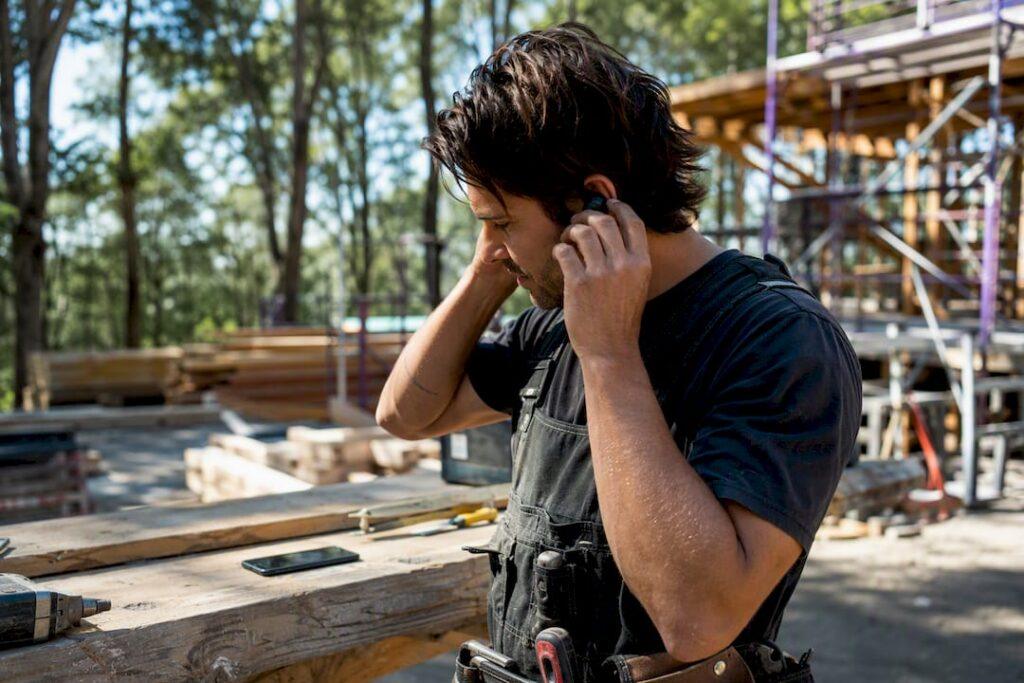 Hands adjusting call headset microphone