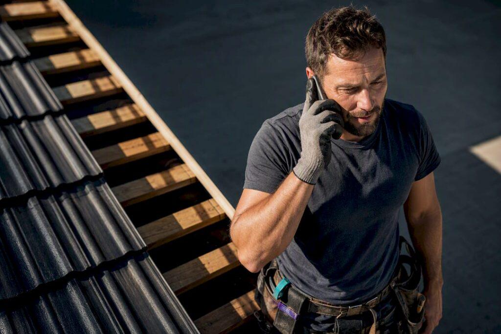 Tradie answering a work call on site